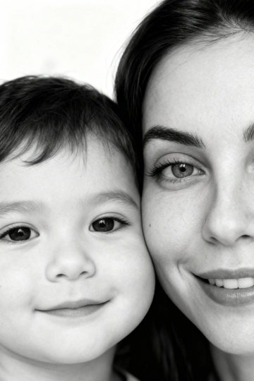 Сверхреалистичная черно-белая художественная фотография 8K женщины и ребенка, снятая очень крупным планом, щека к щеке так что видны только правая половина лица женщины и левая половина лица ребенка. которые смотрят в камеру. Их лица расположены рядом, почти соприкасаясь, образуя идеально сбалансированную симметричную композицию. Каждая деталь передана с фотографической точностью: тонкая текстура кожи и плавные градиенты света и тени. Видимая половина женщины включает ее бровь, один глаз , часть ее носа, щеку и губы, слегка приоткрытые в нежной, естественной улыбке, Видимая половина ребенка включает один глаз , круглую мягкую щеку, часть носа и небольшую улыбку, Фон белый и слегка размытый, что подчеркивает эмоциональную близость между ними. Освещение мягкое и рассеянное, создает деликатный контраст и тональную глубину. На снимке запечатлены нежность, близость и связь между матерью и ребенком, запечатленные с потрясающей реалистичностью. Не меняй черты лиц. 